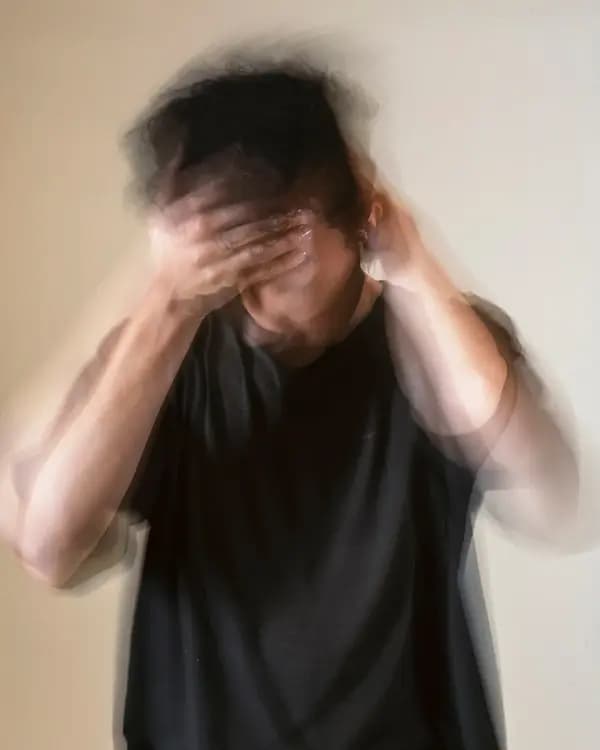 Person experiencing anxiety, hands on head