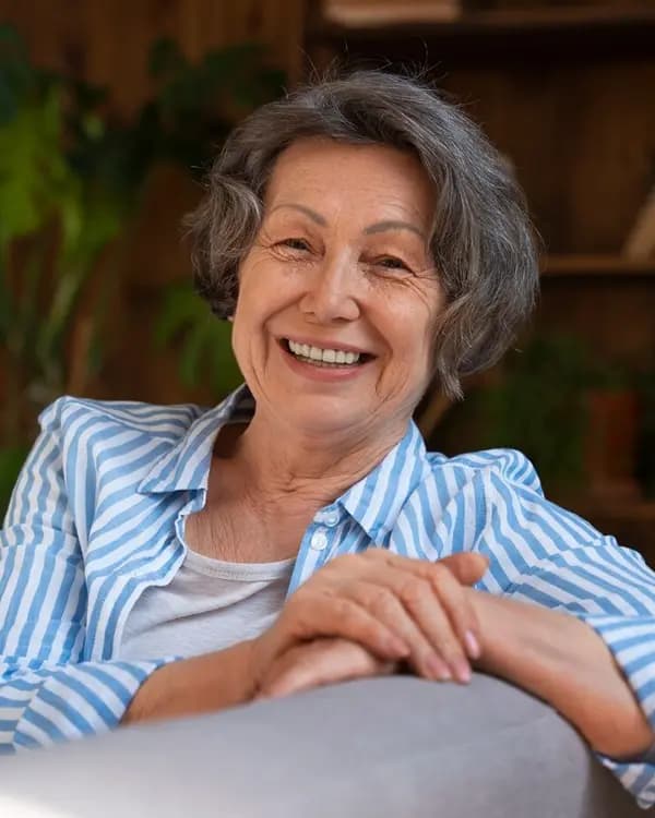 Elderly woman smiling warmly outdoors