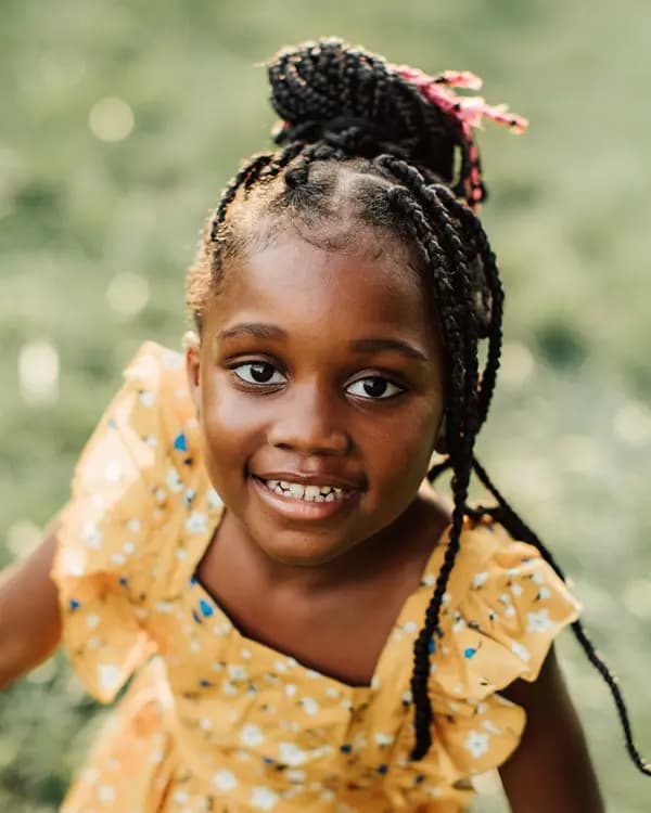 Young girl smiling outdoors